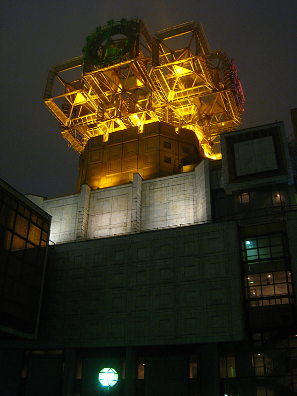 The top of the other side of the building, shorter but still capped with this gold solar panel configuration.