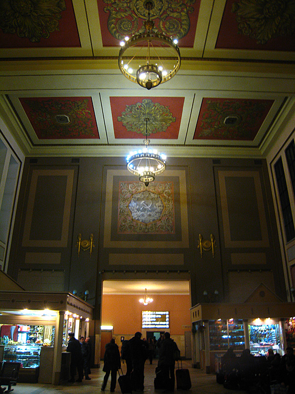 The inside of the Kievskaya station (Kievskaya is adjective form of Kiev). Yes, that is a hammer & sickle on the center of the back wall.