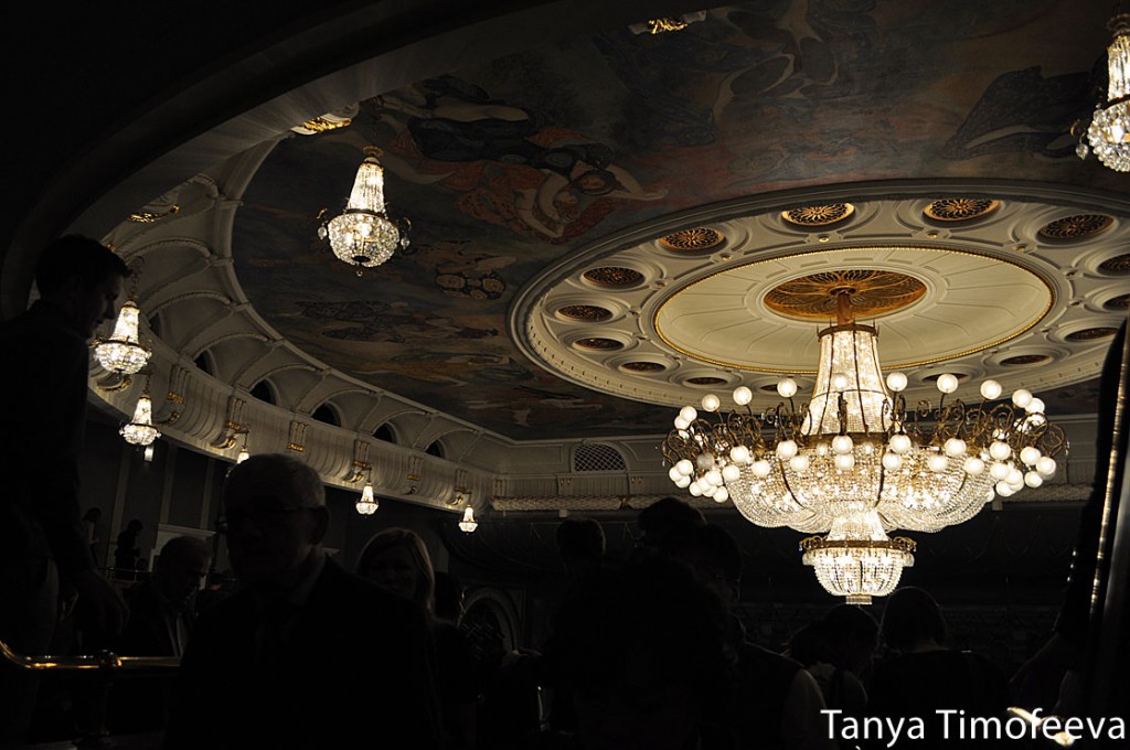 The enormous chandelier and murals on the ceiling.