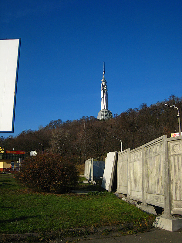 The statue of the motherland. The statue is made of chrome nickel steel and weighs 550 tons. Including the base it stands at 102 meters. In the left hand the figure is holding a shield which is decorated with the state symbol of the USSR. In the right hand there is a sword which weighs 12 tons and is 16 meters long.